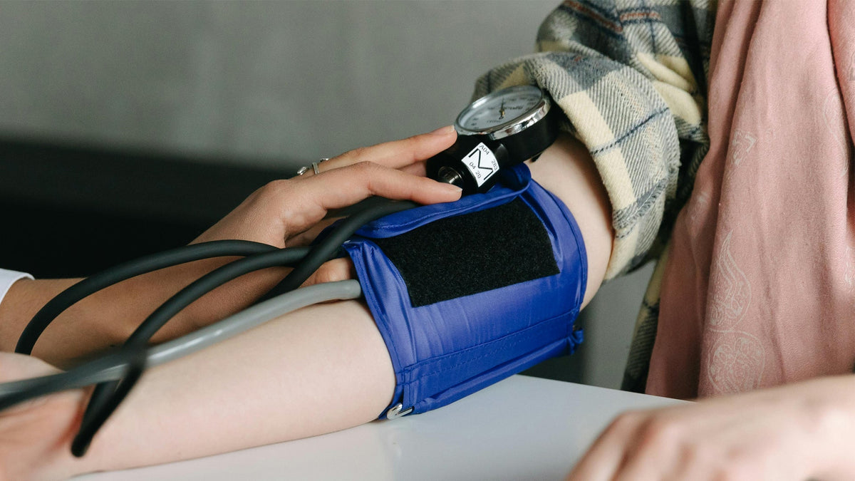 Nine Realms Customer Checking Their Blood Pressure