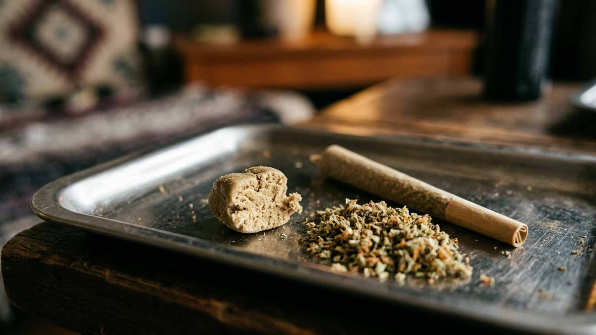 Nine Realms la mousse hash on a metal rolling tray with cannabis flower next to it
