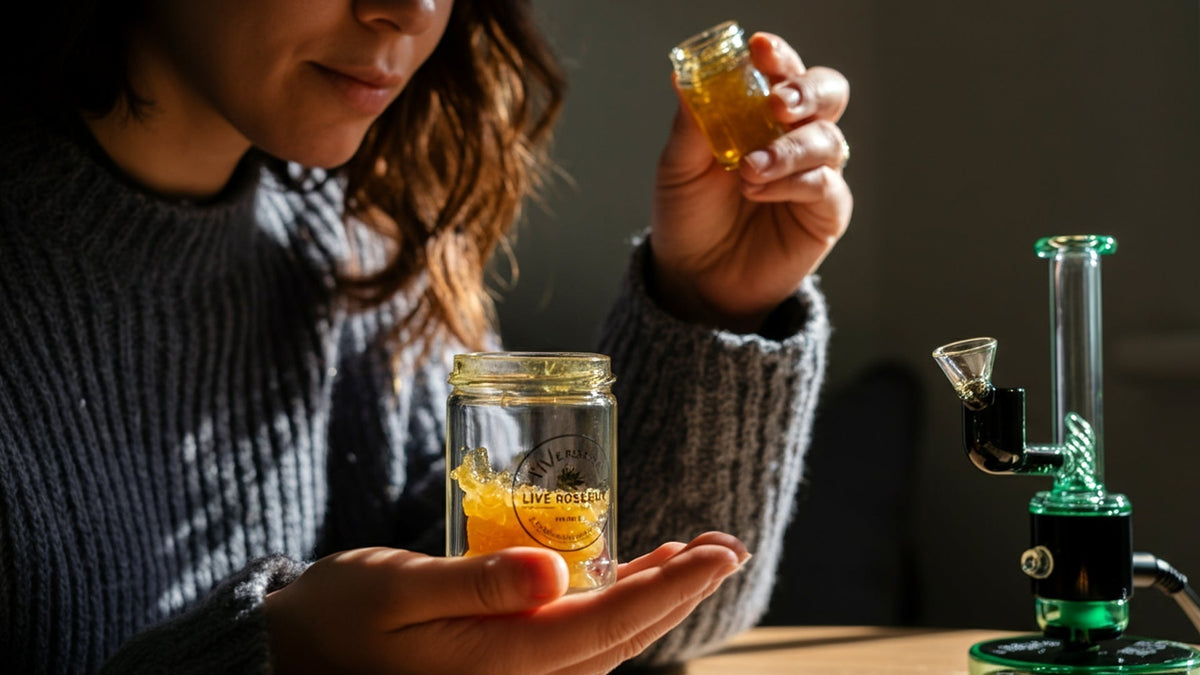 woman holding nine realms live rosin extract in her hands