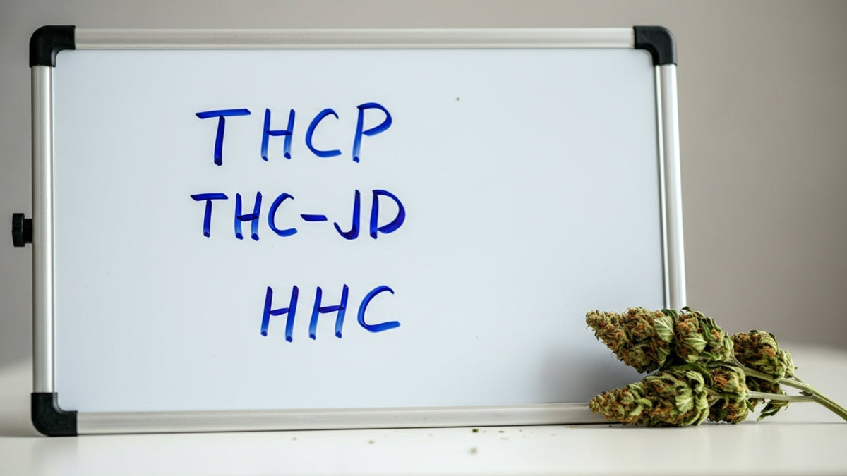 thcp, thc-jd, and hhc written on the white board with nine realms cannabis flower next to it