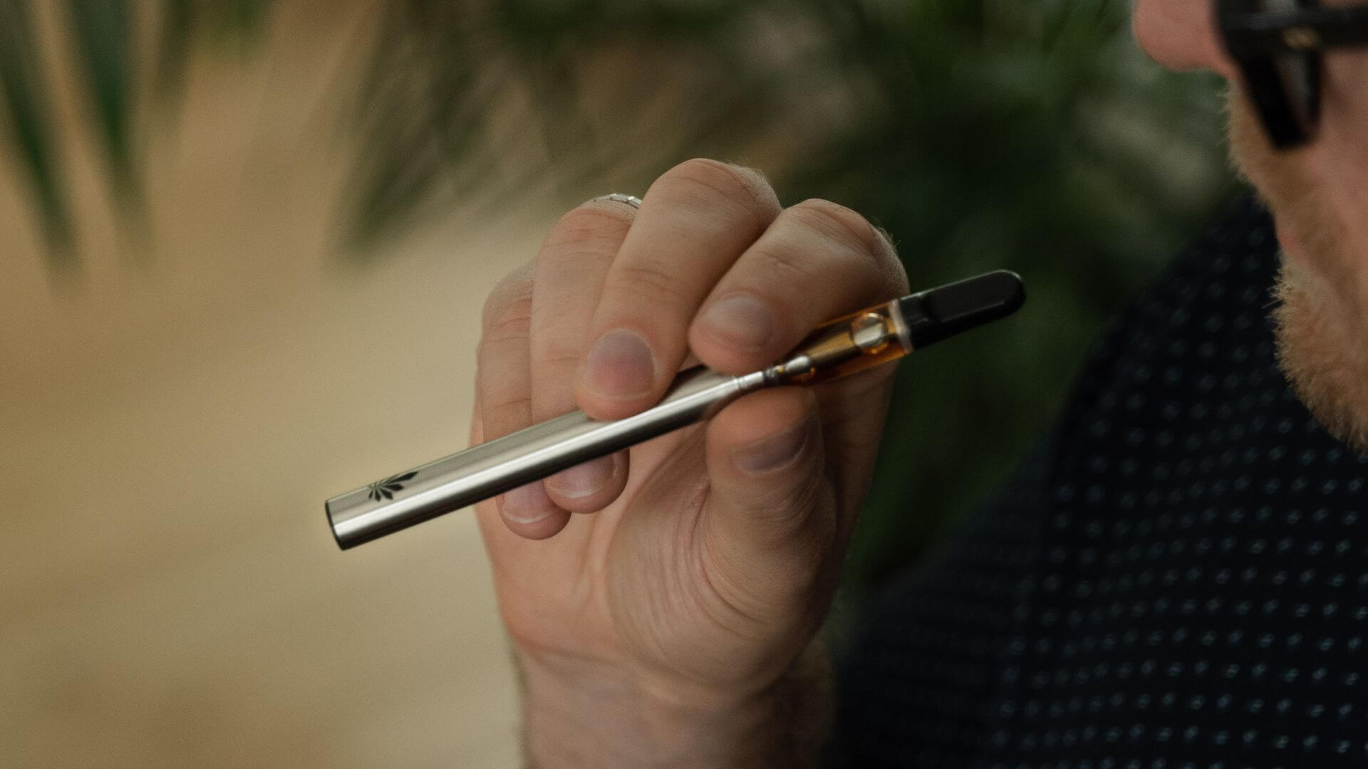 Man holding Nine Realms HHCP Cartridge 