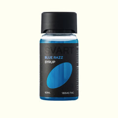 A bottle of Nine Realms SVART Blue Razz THC Syrup, 60ml, featuring a black label with a blue oval graphic and a black cap, set against a solid off-white background.