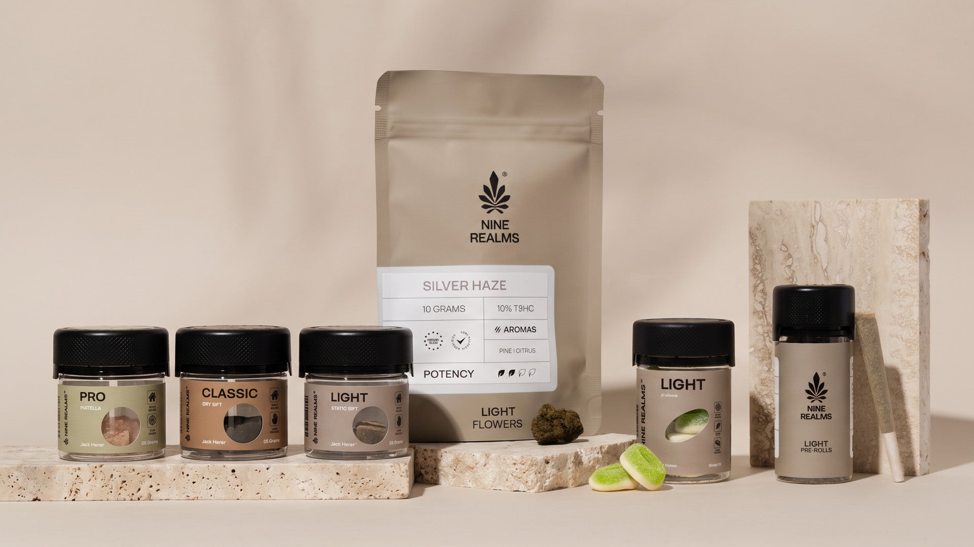 Nine Realms LIGHT and Hash cannabis product composition on a beige background and stones with gummies, pre-rolls, hash and flowers.