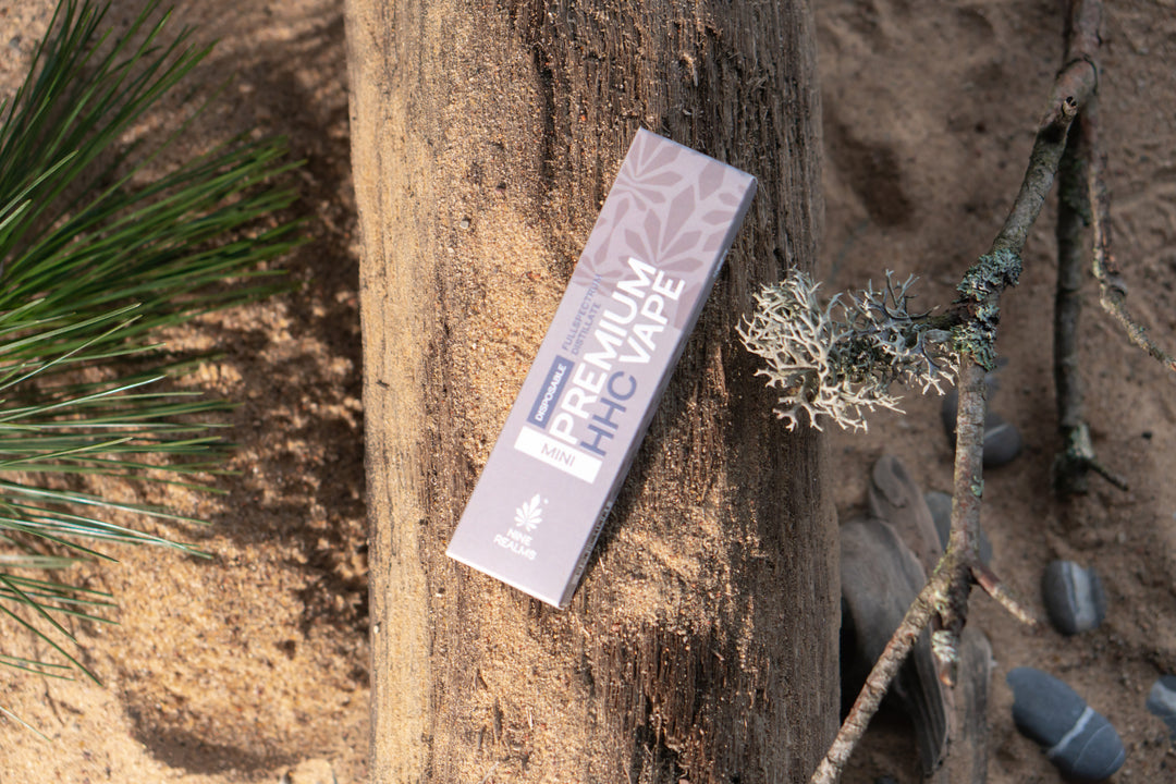 nine realms premium disposable hhc vape packaging in a natural artistic beach composition 